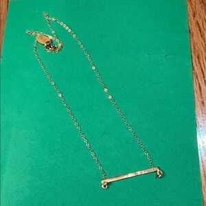 Lisa Leonard 14 karat gold bar necklace with three diamonds.